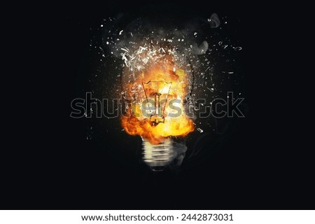 Creative light bulb explodes with fire with fragments and smoke on a black background, concept. Think differently creative idea concept. Dry paint splatter. Brainstorm and think