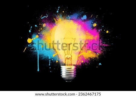 Creative light bulb explosion with splashes of yellow, blue and pink paint on a black background. Think differently, creative idea. Brainstorm