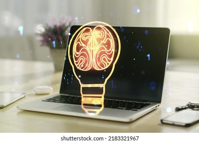 Creative light bulb with human brain hologram on modern laptop background, artificial Intelligence and neural networks concept. Multiexposure