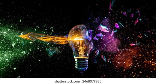 Creative  light bulb shattering colorful sparks adark backdrop - Powered by Shutterstock