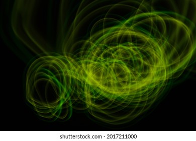 Creative Light Painting Using Bright Green Light Source.The Light Painting Is Isolated From The Black Background. Painting Concept.Movement Of Light.Motion Blur Concept.