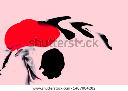 Creative liquid black and red ink fluid texture on pink background. Minimalistic trendy style. Hand painted wallpaper. Modern contemporary art. Isolated backdrop. Fluid art wallpaper in cinese style