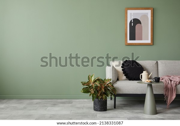 Creative living room interior composition with\
modern sofa, home decorations and personal accessories. Eucalyptus\
wall. Template. Copy\
space.