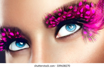 Creative Makeup. False long purple eyelashes closeup. Beauty model woman face make-up with fantasy bright eyelash - Powered by Shutterstock