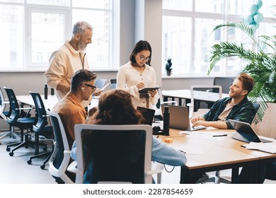 Creative male and female designers discussing paperwork and informative ideas for development startup project during collaboration in office workspace, professional people with modern technology - Powered by Shutterstock