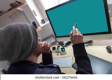 Creative man pointing at desktop screen with a digital  graphics pen.  - Powered by Shutterstock