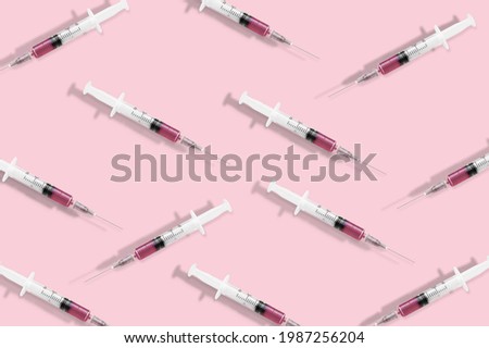 Creative medicinal pattern from syringes of colored background. Colorful concept of New Corona virus