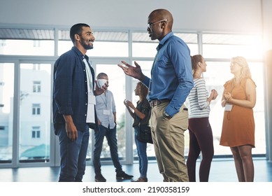 Creative men talking at networking event, sharing startup ideas and discussing new innovation at business conference. Diverse group of people meeting, collaborating or having a conversation in - Shutterstock ID 2190358159