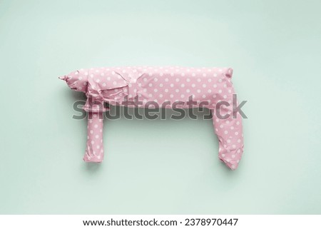 Creative men's gift concept. Electric drill wrapped in pink polka dot gift paper on a blue pastel background. 
