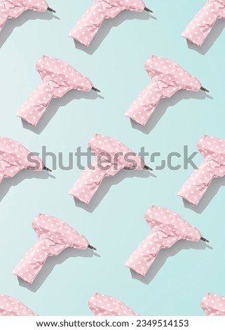 Creative men's gift concept. Pattern of screwdrivers wrapped in pink gift paper. 