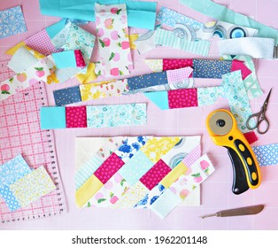 Creative Mess: Fabric Scraps, Scissors, Rotary Cutter, Seam Ripper, Quilting Ruler And Cutting Mat