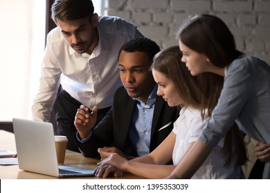 Creative millennial team led by african team leader brainstorm together analyse data look at pc screen, executive manager explains to colleagues new online project startup. Teamwork mentoring concept - Powered by Shutterstock