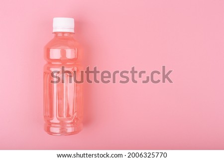 Creative minimal composition with pink drink in transparent plastic bottle against bright pink background with copy space. Concept of refreshing or detox drinks for dieting, clean eating and healthy l Photo stock © 