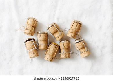 Creative minimal pattern of wine cork from sparkling wine on white fur, bottle stoppers top view wooden champagne corks with mushelets. Happy New Year concept, xmas, Christmas holidays trend photo.