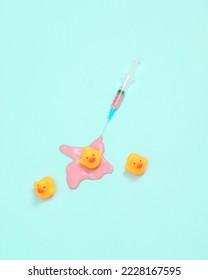Creative minimalist layout. syringe with ducks on pinkbackground. Surreal medicine idea. Conceptual pop