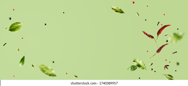 Creative Mockup With Flying Various Types Of Spices Bay Leaf, Red Chili Pepper, Anise On Green Background With Copy Space. Long Food Banner With Copy Space.