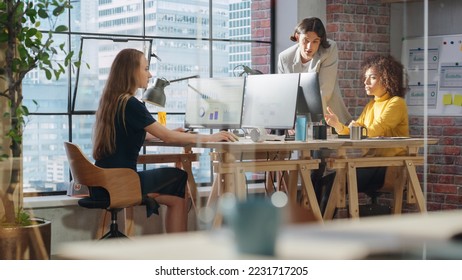 Creative Multicultural Colleagues Collaborate on a Project and Work Together as a Team. Marketing Manager and Designer Talking and Discussing Changes to an Advertising Campaign for a Startup. - Powered by Shutterstock