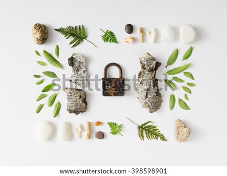 Creative natural layout made of leaves, stones, and tree bark on white background. Flat lay.