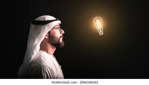 Creative new idea. Innovation, brainstorming, inspiration and solution concepts. Arab man wear glasses looking to light bulb. - Shutterstock ID 2066106263