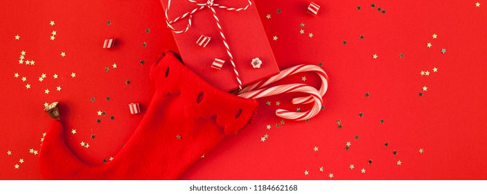 Creative New Year Christmas Presents Wrapped Ribbon Flat Lay Top View Xmas 2019 Holiday Celebration Handmade Gift Boxes Noel Stocking On Red Paper Background Copyspace. Long Wide Banner