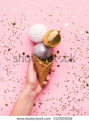 Creative New Year ice cream of Christmas balls on pink background