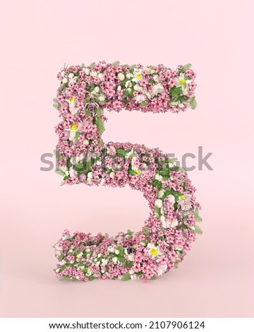 Creative number 5 concept made of fresh Spring wedding flowers. Flower font concept on pastel pink background.