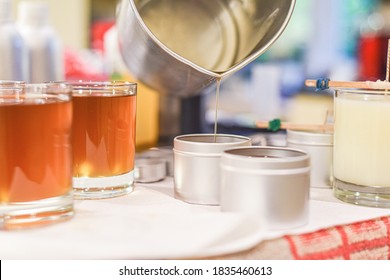 Creative Occupation Of Candle Making Showing The Pouring Of Liquid Wax Into Jars