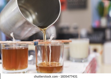 Creative Occupation Of Candle Making Showing The Pouring Of Liquid Wax Into Jars