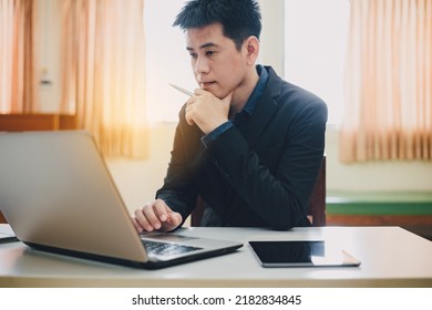 Creative Office : Young Asian Businessman Working On Table Computer. Busy Millennial And Stressful Start Up Business Person Work In Office.