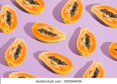 Creative Orange Papaya Pattern On Pastel Purple Background. Fresh Summer Aesthetic. Bright Colorful Arrangement.