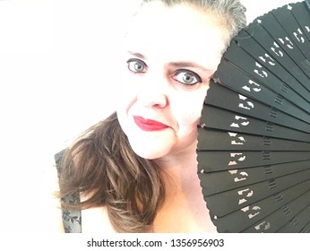 Creative Overexposed Portrait Of A Woman With Gray Eyes With A Spanish Fan