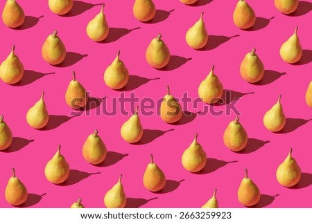 Creative pattern made with fresh pears against pastel pink backround.Minimal summer fruit layot.