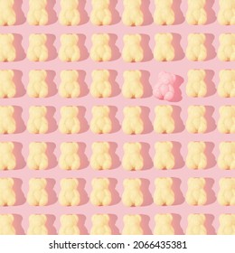 Creative Pattern Made With Pastel Yellow Gummy Bears And One Pink Gummy Bear On Pastel Pink Background. Retro Style Aesthetic Idea. Minimal Candy Concept.