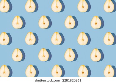 Creative pattern made of raw sliced pear on blue pastel background with shadows. Minimal style. Healthy food ingredient concept. Top view. Flat lay