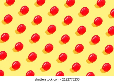 Creative Pattern Made Of Red Macaroons On Yellow Background. Dessert And Confectionary Concept.