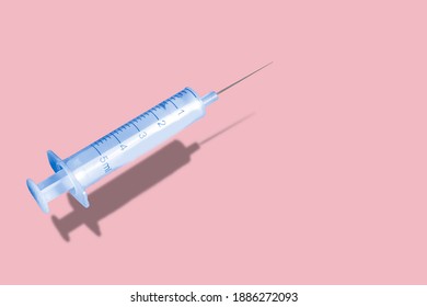 Creative pattern made with a syringe on blue background. New Corona virus infection (novel corona virus disease) vaccine. Pandemic concept.Colorful concept of New Corona virus 2019-nCoV or COVID-19 va