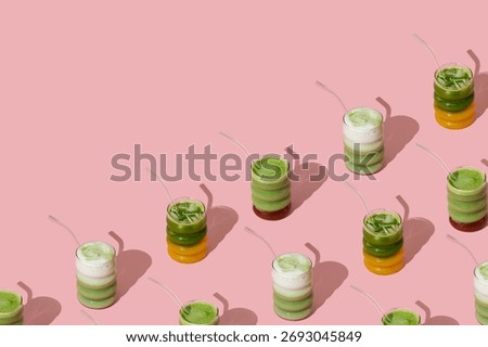 Creative pattern made with various colorful matcha drinks on pastel pink background with copy space. Minimal healthy matcha tea concept. Trendy drink idea.