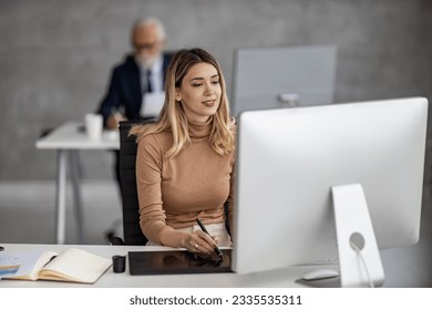 Creative people meeting in an office using laptop and talking about new plans.Web designers working at office and planning new website. - Powered by Shutterstock