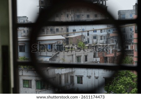 A creative perspective through a circular object, capturing a blurred urban scenery beyond. The image emphasizes uniqueness and encourages artistic inspiration with its focus on geometry 