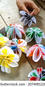 Creative photo of children with origami paper, children making origami flower-shaped paper.
