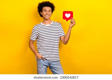 Creative photo of young smiling guy student hand pocket hold paper like icon social media popularity isolated on yellow color background - Shutterstock ID 2300542817