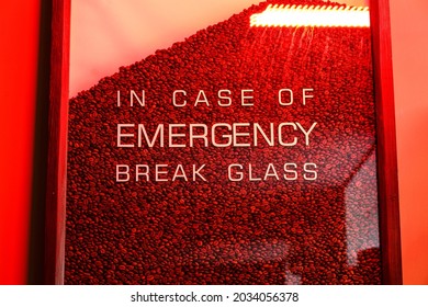 Creative phrase in coffee shop. Glass full of coffee beans and the text. In case of emergency break glass