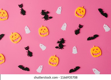 Creative pink pattern made of bats, witches, ghosts and jack-o'-lantern Minimal flat lay. Halloween concept.