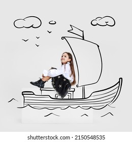 Creative portrait of cute kid, little girl sailing on drawn boat isolated on grey background with pencil sketch. Concept of emotions, ideas, imagination, international children's day. Happy child - Shutterstock ID 2150548535