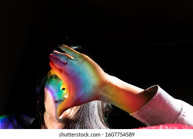 Creative Portrait. Woman Lying In Bed With Colorful Light Reflection On Her Face With Focus On Look Creative Portrait, Art Portrait