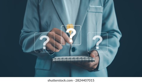 Creative problem solving and idea generation concept featuring a business professional writing in a notebook with question marks and a light bulb symbol, representing innovation, critical thinking.