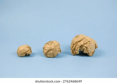 creative process seen through paper, kraft paper balls symbolize artistic experimentation stages, textural wrinkles and empty spaces emphasize decisionmaking in creative development phases