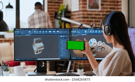 Creative professional uses 3D modeling software to design industrial prototypes, using copy space display. Home office setup showcases innovation, technology and modern tech tools. Camera B.