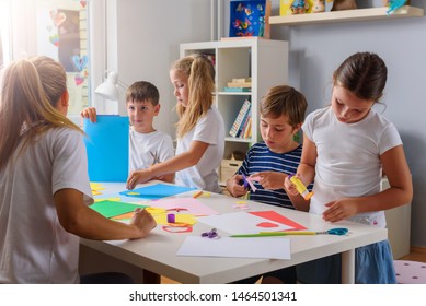 Creative Projects With Children At Home Or At School. Kids Making Some Paper Crafts. Teacher With Kids.