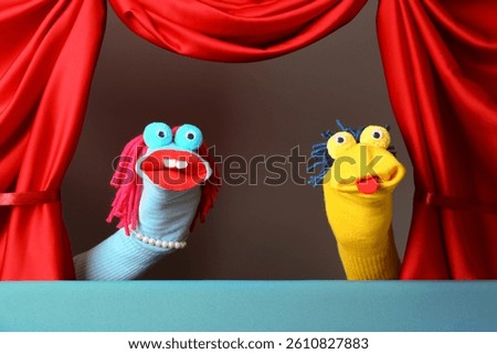 Creative puppet show on stage with red curtains